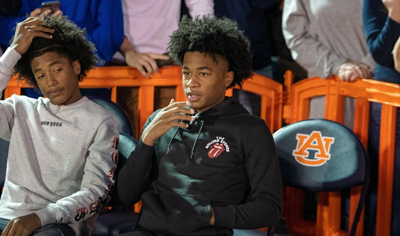 5-star auburn signee sharife cooper (right) watches the court