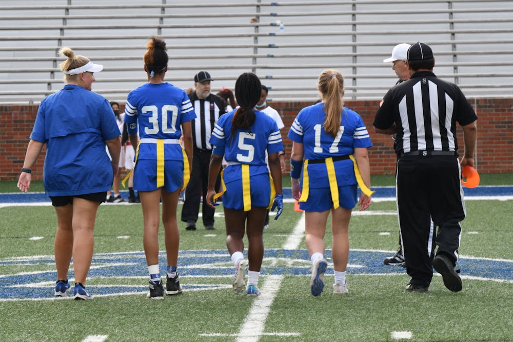 Coach Link and her captains take the field for the coin toss