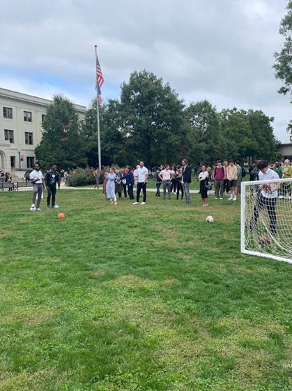 NFL Cornerback Josh Norman and soccer star Oguchi Onyewu taking free kicks on the quad