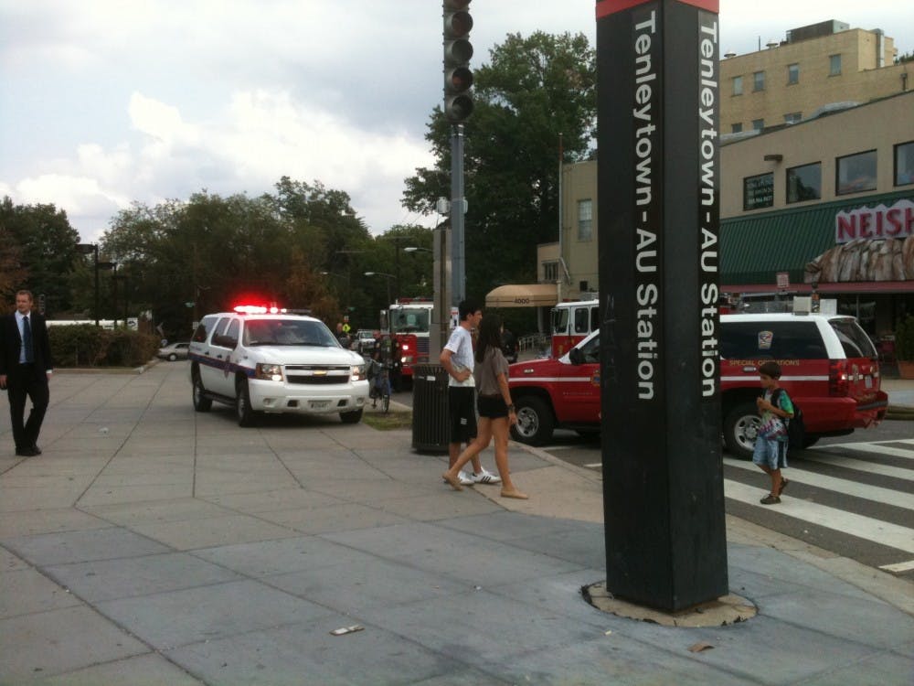 Fire trucks and police cars sit outside the Tenleytown Metro station after responding to reports of a smoking escalator.