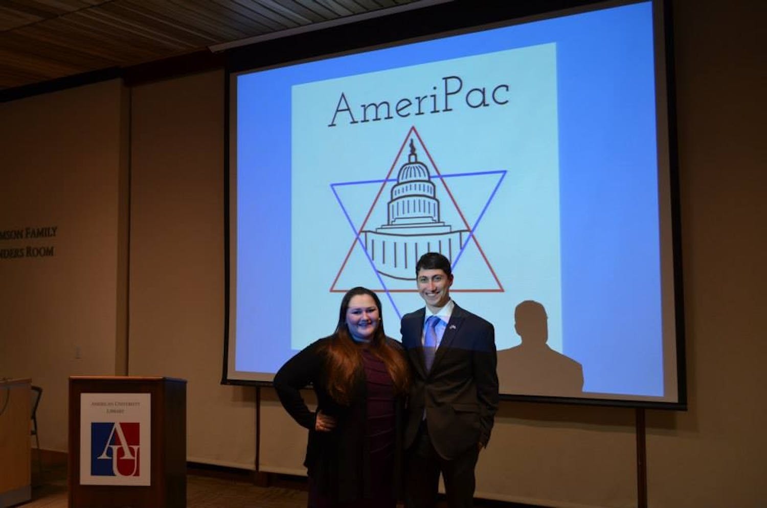 	College Republicans Vice President Zoe Crain (left) and College Democrats President Alex Hoffman (right) pose for a picture after the AmeriPac Leadership Dinner.