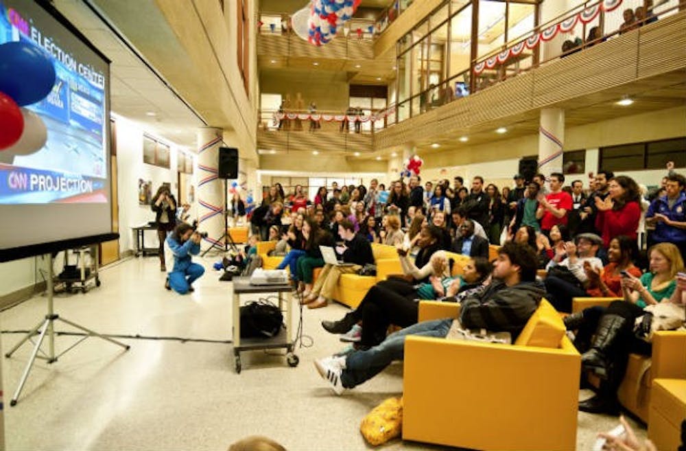 AU students watch the 2012 presidential election unfold on a TV screen in the School of International Service.