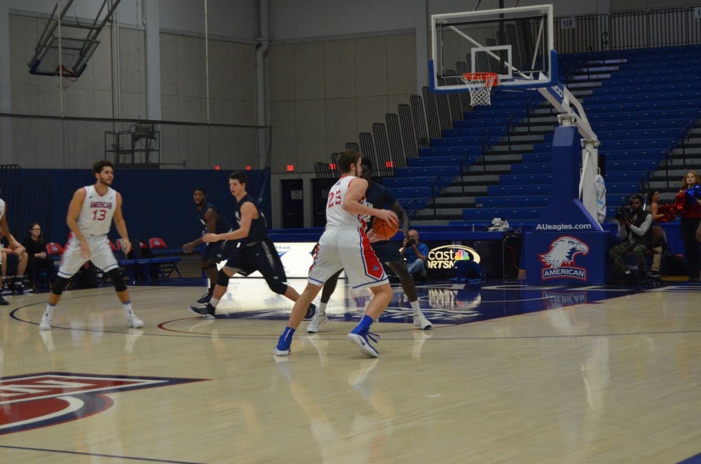 Freshman forward Mark Gasperini drives to the basket against a New Hampshire defender in a non-conference game&nbsp;on Dec. 6.&nbsp;