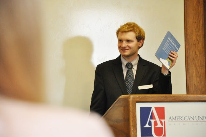 â€˜Clocks and Cloudsâ€™ Editor-In-Chief Ben Mainwaring holds up a copy of the research journal. 