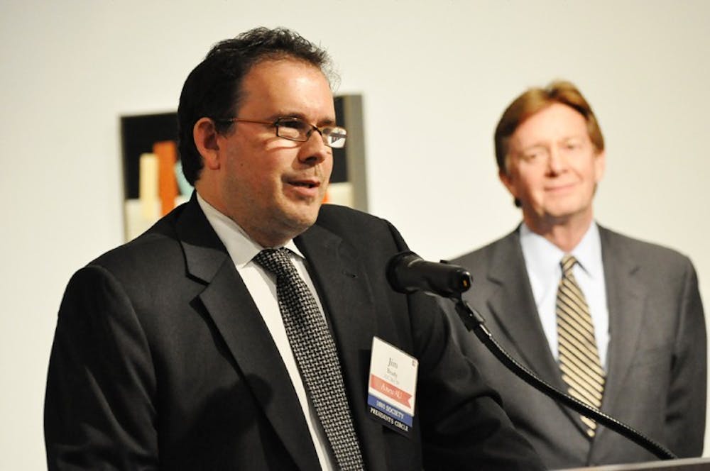 Jim Brady, a 1989 alumnus of the School of Communication, receives the Alumni Achievement Award Saturday as AU President Neil Kerwin looks on.
