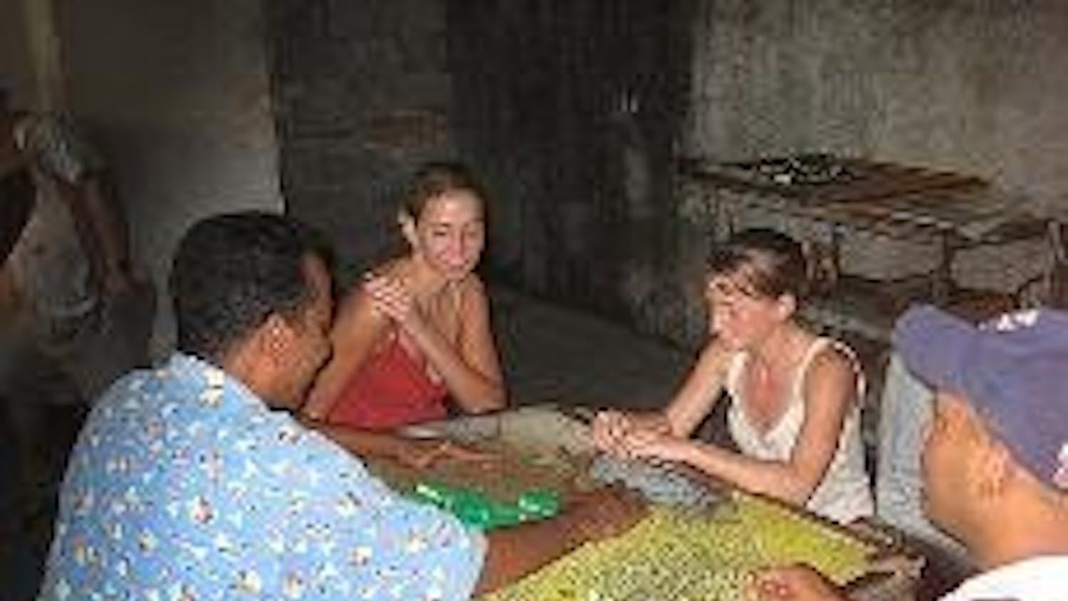 CULTURES CONVERGE - AU students play dominoes with Cuban citizens. A group of AU students are in the country this semester as part of an AU Abroad enclave program. They have incorporated the current political transition into their classes.