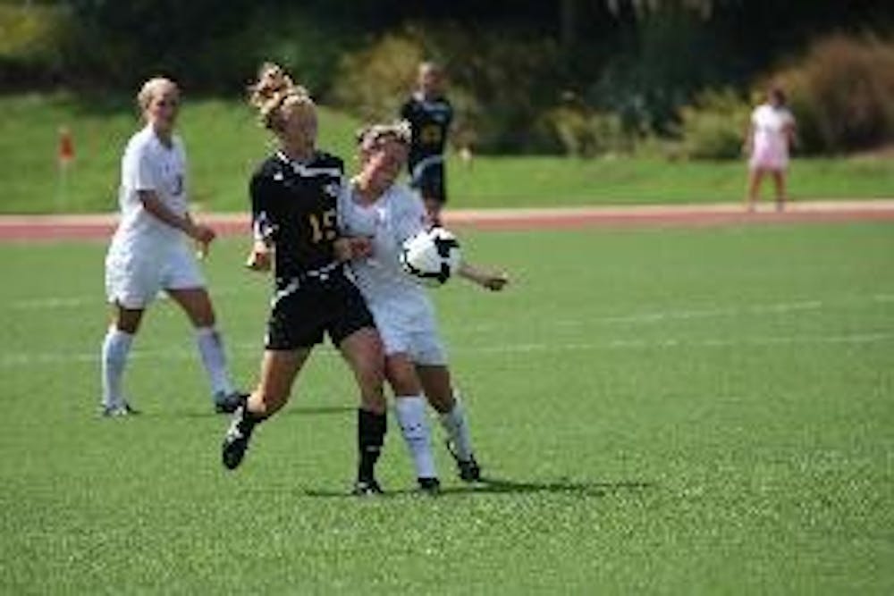 PULLING AHEAD EARLY - Sophomore midfielder Marissa Crollett fights for the ball against her Towson Tiger opponent in the women's soccer match on Saturday.  AU defeated Towson 1-0 with senior forward Krystn Hodge goal in the eighth minute to give the Eagle