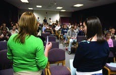 SMOKING RECONSIDERED - Georgette Spanjich (left) and Amanda Hurley explain different smoking policy options during a student-led forum. Overall, students supported a courtesy policy that would encourage students to be considerate of the current smoking co