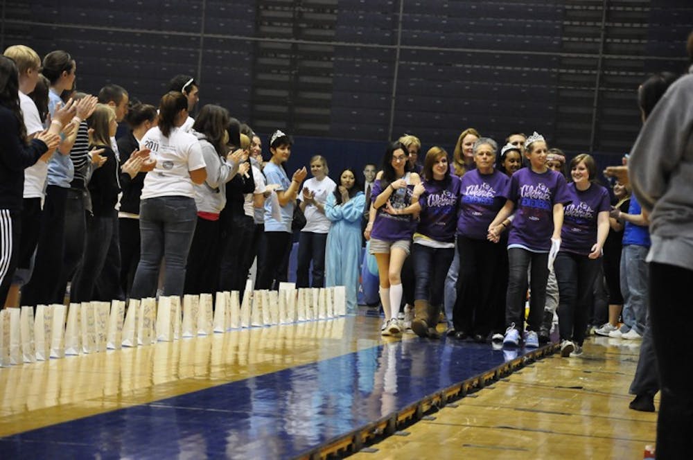 VICTORY LAP â€” Survivors take a lap around Bender Arena April 2 as part of AUâ€™s annual Relay for Life. The first lap featured survivors, the second lap included their caregivers and all participants joined in for the last lap. AU raised a record $82,000 for the American Cancer Society with more than 1,099 people registered for the 12-hour event. 