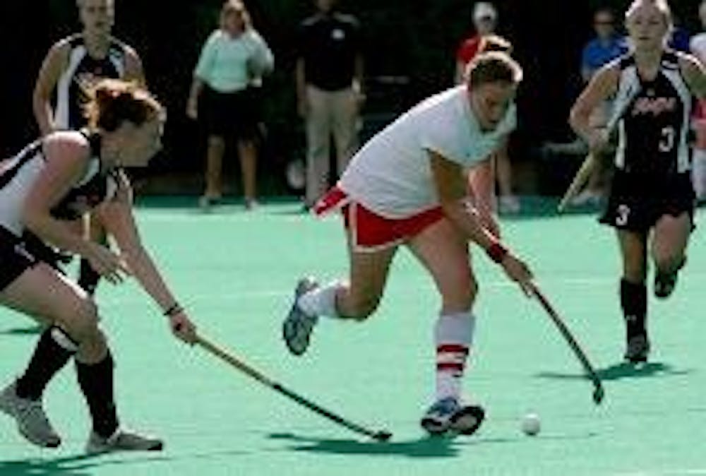 CHARGING THE FIELD-Junior Irene Schickhardt dribbles the ball down the field, trying to avoid her Terrapin opponents. The Eagles failed to keep their undefeated record, losing to the Maryland Terrapins in Wednesday's game. The sidelines were packed for th