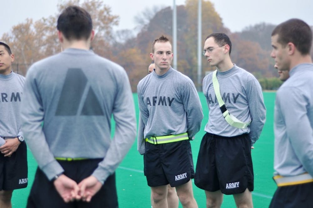 STANDING AT ATTENTION â€” ROTC cadets wait for instructions during their morning physical training at Georgetown University. This semester, AU cadets will be able to use fitness facilities here.  	