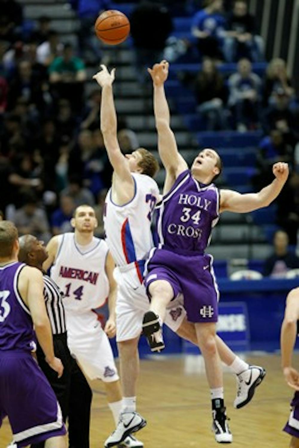 JUMPING UP â€” Stephen Lumpkins fights for a ball in the air against Holy Cross as Vlad Moldoveanu looks on during Saturdayâ€™s â€œPhil Benderâ€ event. AU won 71-64 and gave Head Coach Jeff Jones his 300th win at AU. It was the Eaglesâ€™ second win in Patriot League play. 