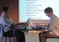 UP CLOSE AND PERSONAL - Larry (Kyle Encinas) and Dan (Marc Thuot) chat with each other in "Closer." Dan is staging a romantic assault on love interest Anna, enticing Larry with Anna's "epic tits" and "love of cock." Dan sets up a situation where Larry mee