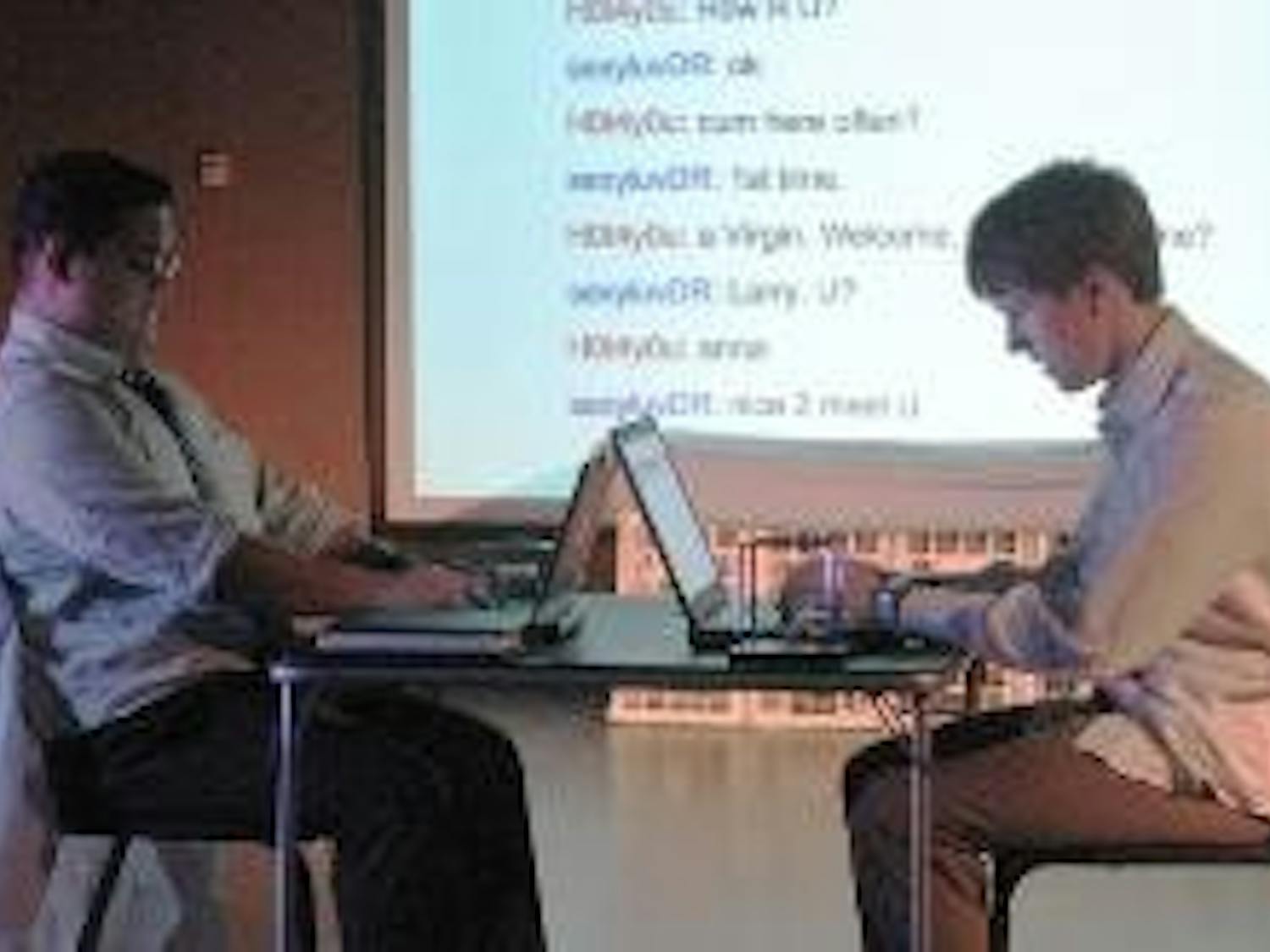 UP CLOSE AND PERSONAL - Larry (Kyle Encinas) and Dan (Marc Thuot) chat with each other in "Closer." Dan is staging a romantic assault on love interest Anna, enticing Larry with Anna's "epic tits" and "love of cock." Dan sets up a situation where Larry mee