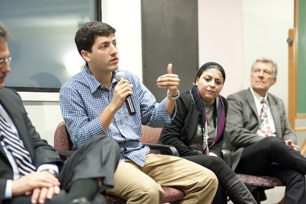 (from left) Larry Diamond, Robert Patino, Esraa Abdel Fattah and Ben Moses speak on a panel about â€œA Whisper to a Roar.â€