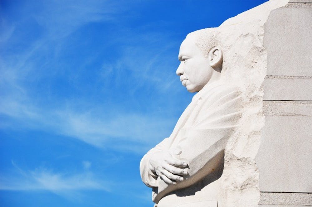 A STONE OF HOPE - Tourists and Washingtonians pose in front of the new Martin Luther King Jr. Memorial on the National Mall. The memorial opened to the public on Aug. 22 and drew large crowds in its first week.