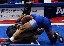 TAKE DOWN- Sophomore wrestler Matt Mariacher takes down his George Mason University opponent in his 141-pound weight class match Feb. 8. Mariacher took a 14-3 major decision as the Eagles remained undefeated at home by beating the Patriots 29-9. The Eagle