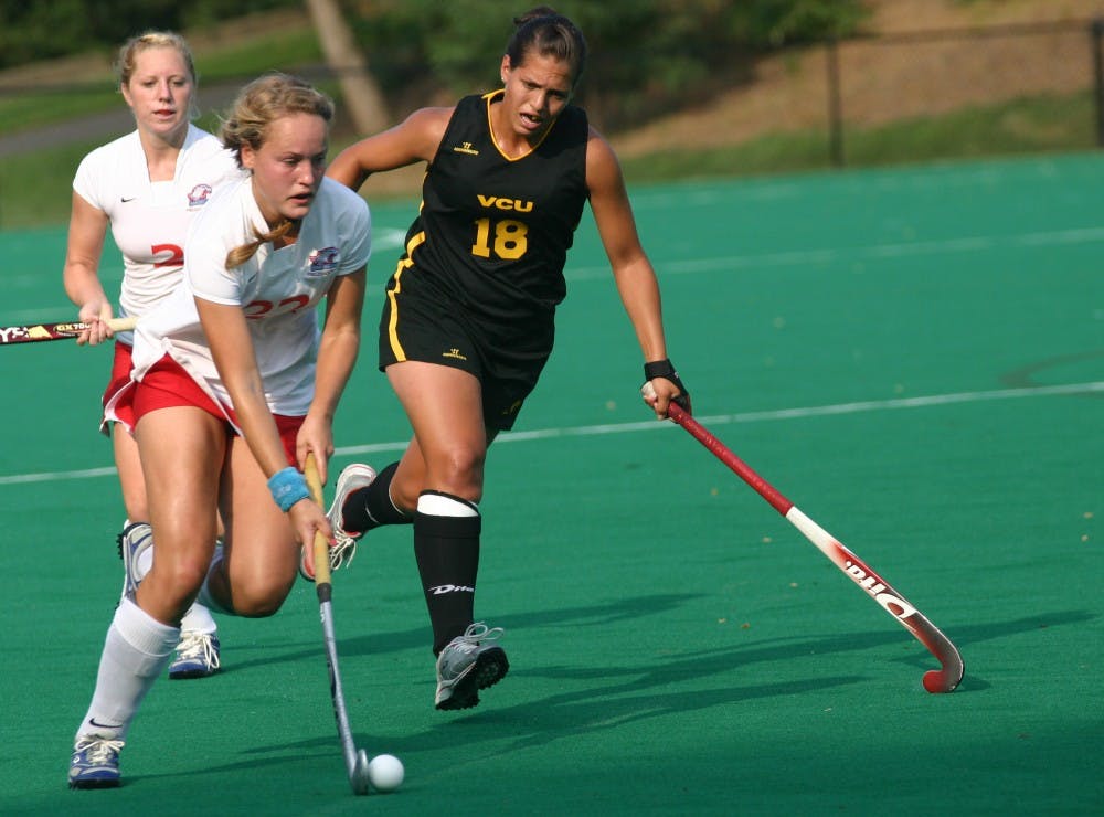 INTERNATIONAL INCIDENTâ€”Ann van Erp clears the ball for AU during a game last year. Van Erp and Christine Fingerhuth are international students who traveled accross the world to play field hockey for the university.