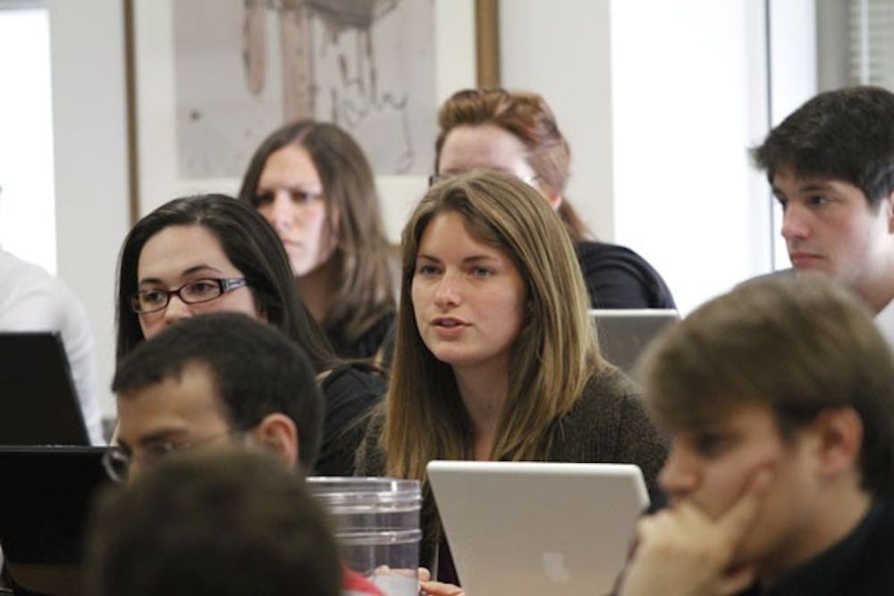 Women\'s Initiative Director Sarah Brown (right) and Co-Director of the Stopping Violence Against Women Campaign Jennifer Dorsey (left) sit amongst undergraduate representatives and members of the public at the Senate meeting where their budget received $1,000 cuts.