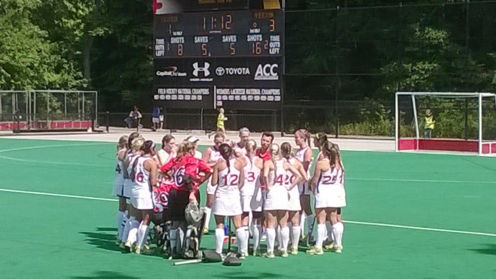 	Steve Jennings talks with the field hockey team during their match against Columbia