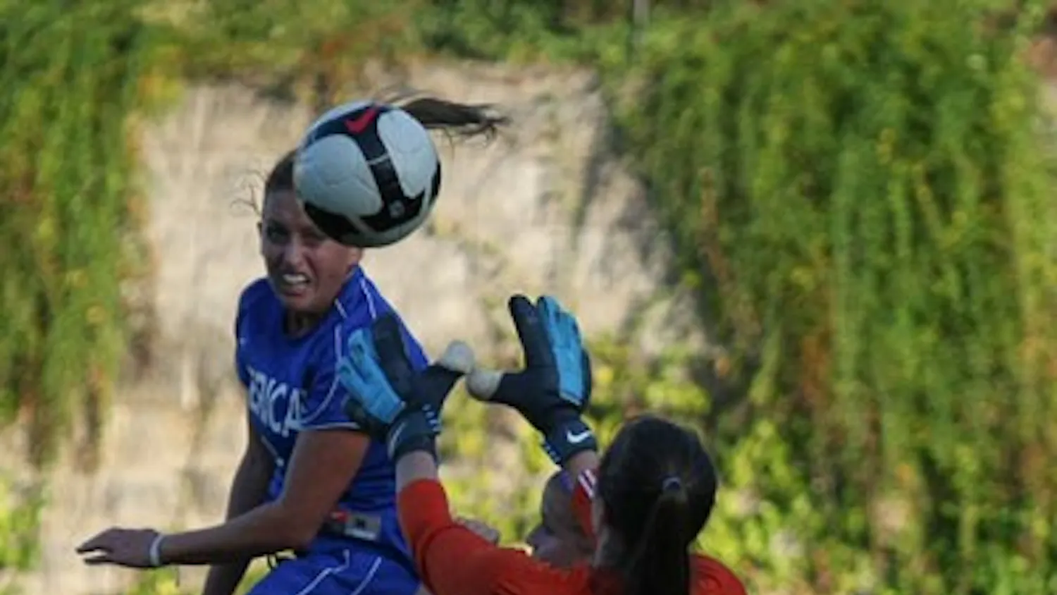 JUMPING UP— Kelsey Brasher jumps up for a ball during AU’s 2-0 win over conference rival Holy Cross on Friday. The win keeps AU perfect in the Patriot League with a 2-0 conference record. AU will play Colgate University on Saturday, who is in the basement of the conference. AU is 7-7 on the year.