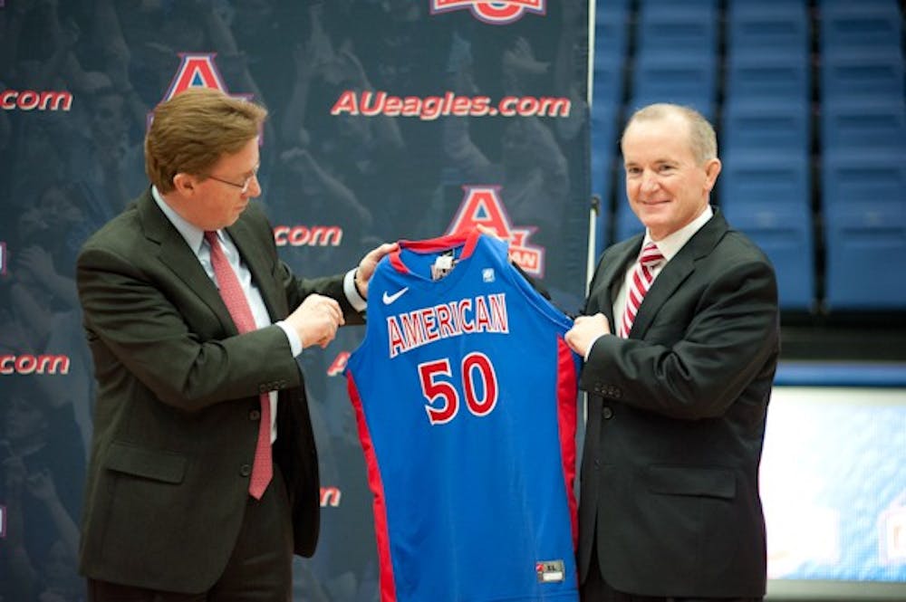 AU President Neil Kerwin gives an AU jersey to Athletic Director Billy Walker.