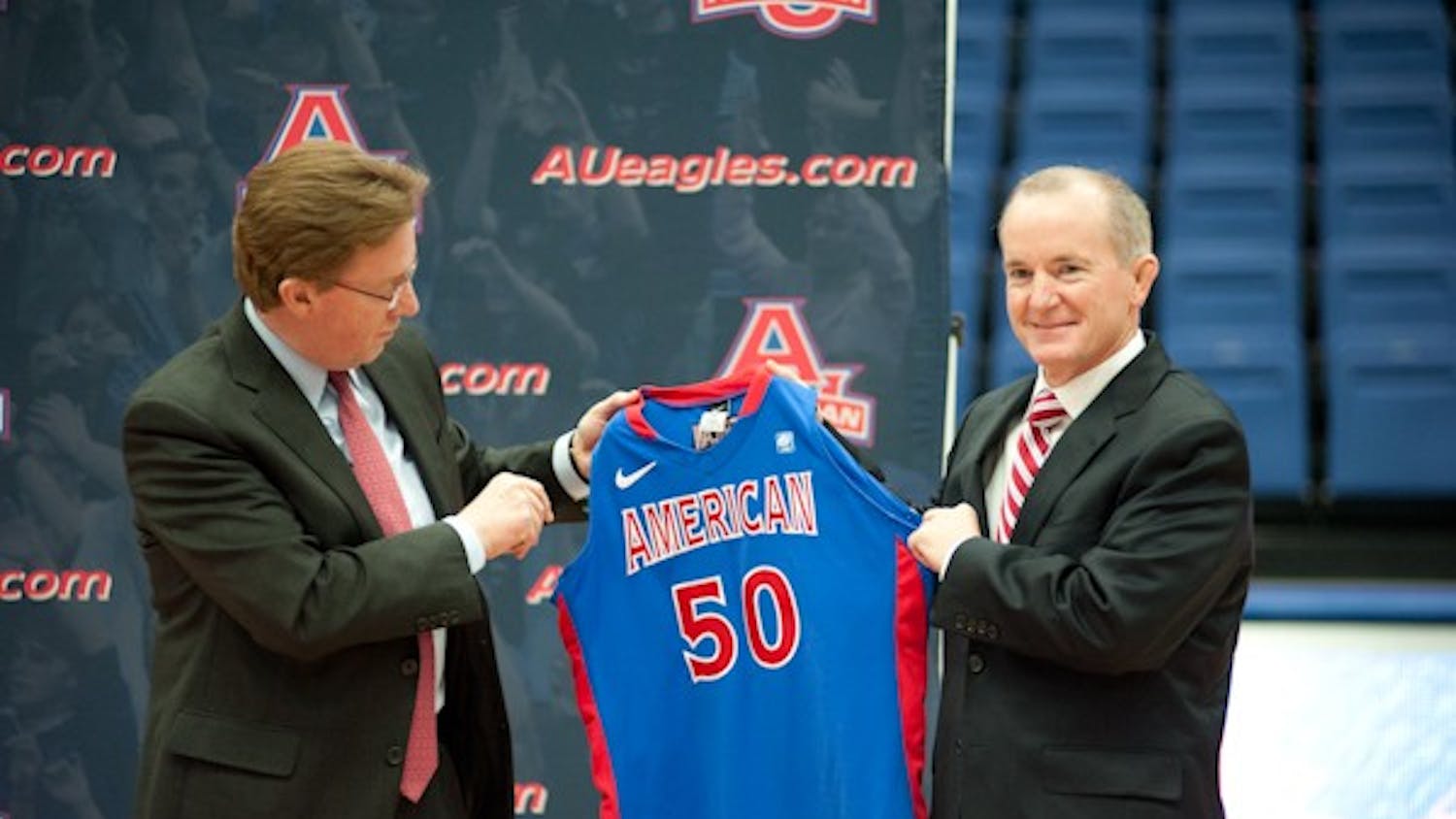 AU President Neil Kerwin gives an AU jersey to Athletic Director Billy Walker.