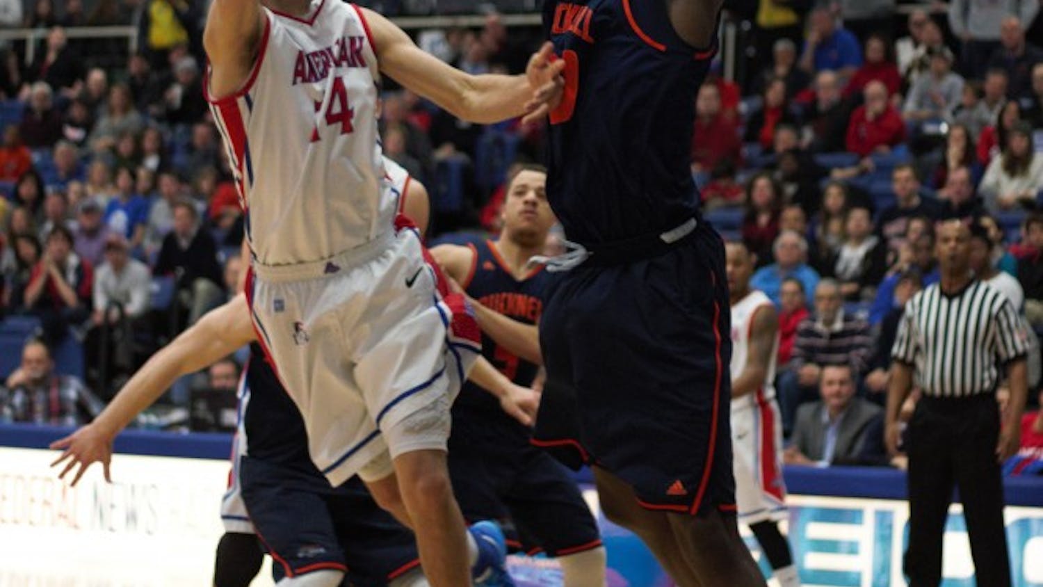 Senior Jesse Reed takes a shot over a Bucknell defender during a game last season. Photo credit: Bryan Park/ THE EAGLE&nbsp;