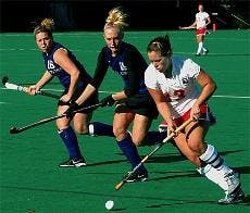 AU senior Kaitlin DeTroia pushes past Holy Cross' Susie Whelan in Sunday's Patriot League championship game. 