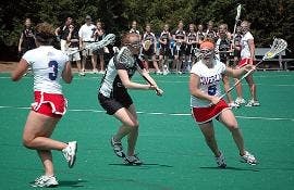 GOING FOR THE GOAL- Junior Leslie Fischer, above, prepares to rip a shot on goal, in Saturday's game against Colgate. Teammate Brit Ferguson, below, moves in to score one of her two goals in the game. The Eagles won 13-10, clinching the Patriot League reg