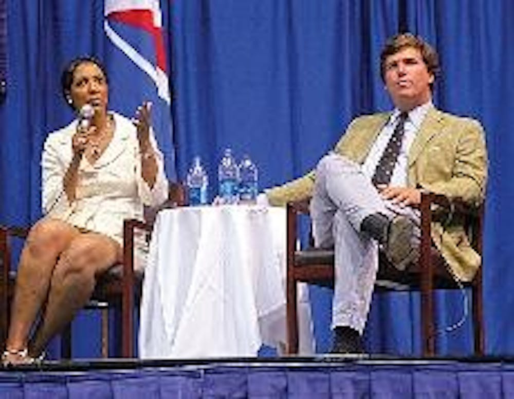 PUT TO THE TEST - Panelists Michelle Bernard (left) and Tucker Carlson (right) discuss President Obama's first 100 days in office. The two split on the wisdom of his decisions. 