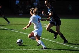 FANCY FOOTWORK - Sophomore midfielder Marissa Crollett attempts to keep the ball in bounds while dribbling around her opponent in the Eagles' recent loss to George Washington on Tuesday afternoon.  AU lost their fourth consecutive game after a GW goal in 