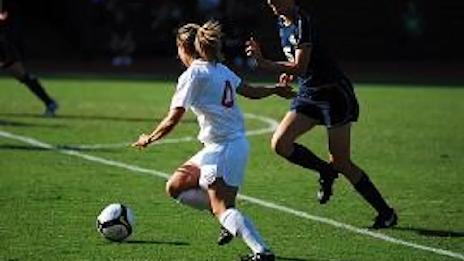 FANCY FOOTWORK - Sophomore midfielder Marissa Crollett attempts to keep the ball in bounds while dribbling around her opponent in the Eagles' recent loss to George Washington on Tuesday afternoon. AU lost their fourth consecutive game after a GW goal in