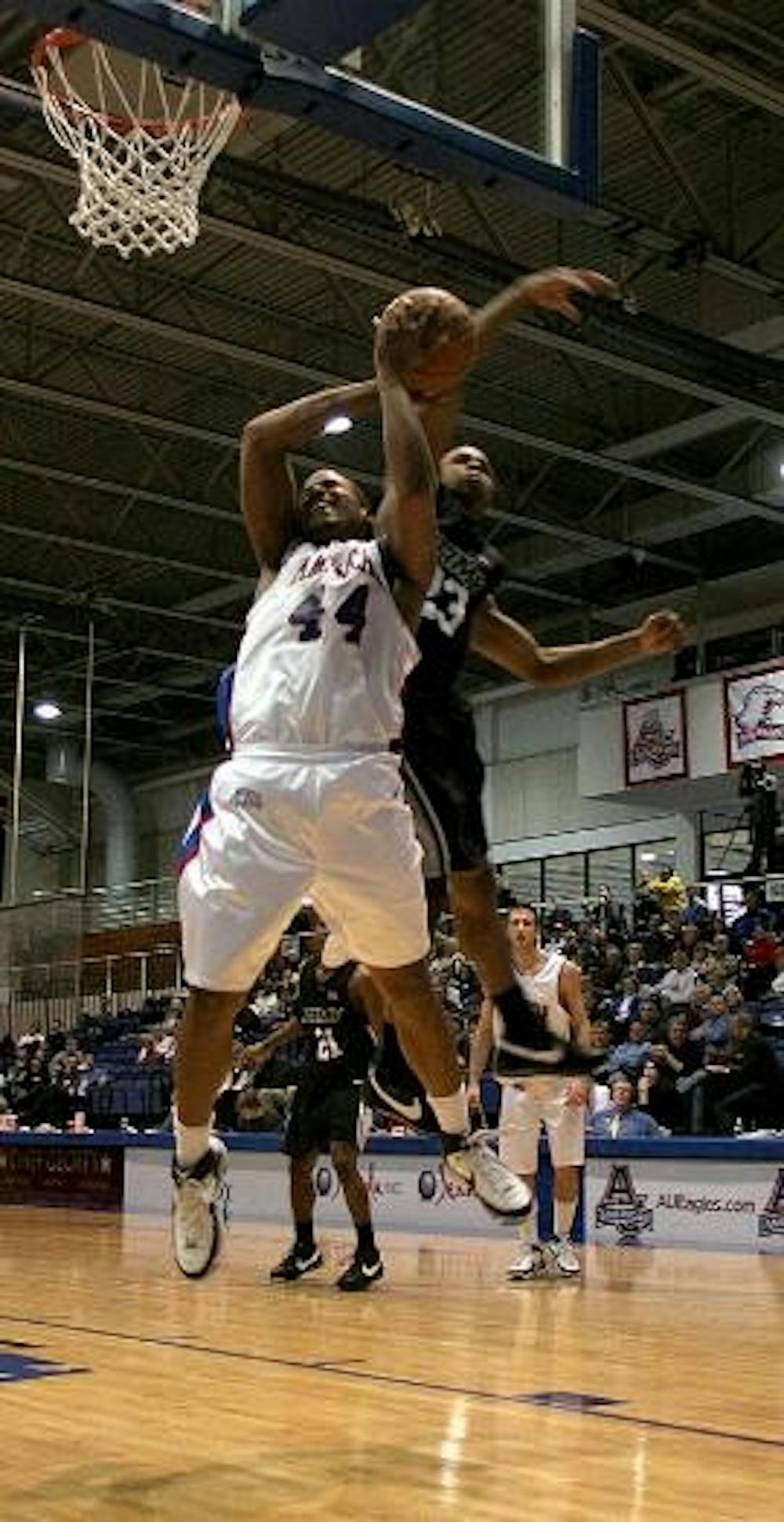 IN FLIGHT - Junior forward Jordan Nichols avoids the block with all of his might as he attempts to make a shot in last night's game in Bender. AU won their sixth straight game, putting them in first in the PL.