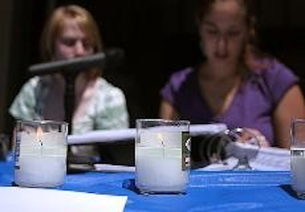 VENERATING VICTIMS - Holocaust Remembrance Week Chair Rachel Regberg and Sasha Block, a sophomore in the School of International Service, take turns reading a list of names of victims of the Holocaust on the front steps of the Kay Spiritual Life Center ye