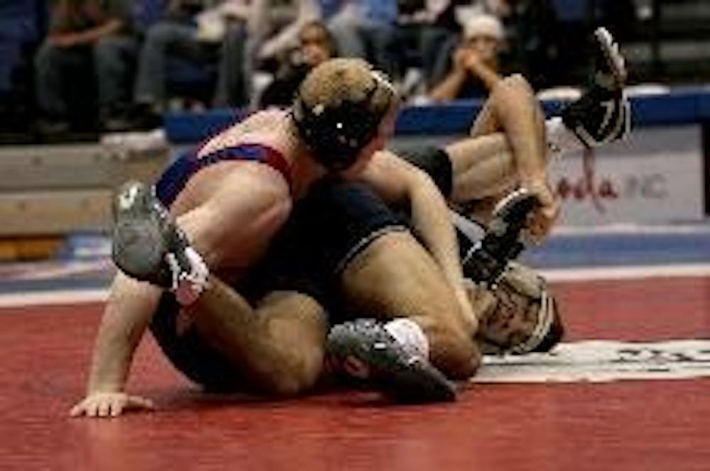 Though red shirt sophomore Mike Cannon (above left) won his bout in the 165-lb. weight class at yesterday's home wrestling match, only three of his teammates were able to do the same. Old Dominion came out on top 31-12.