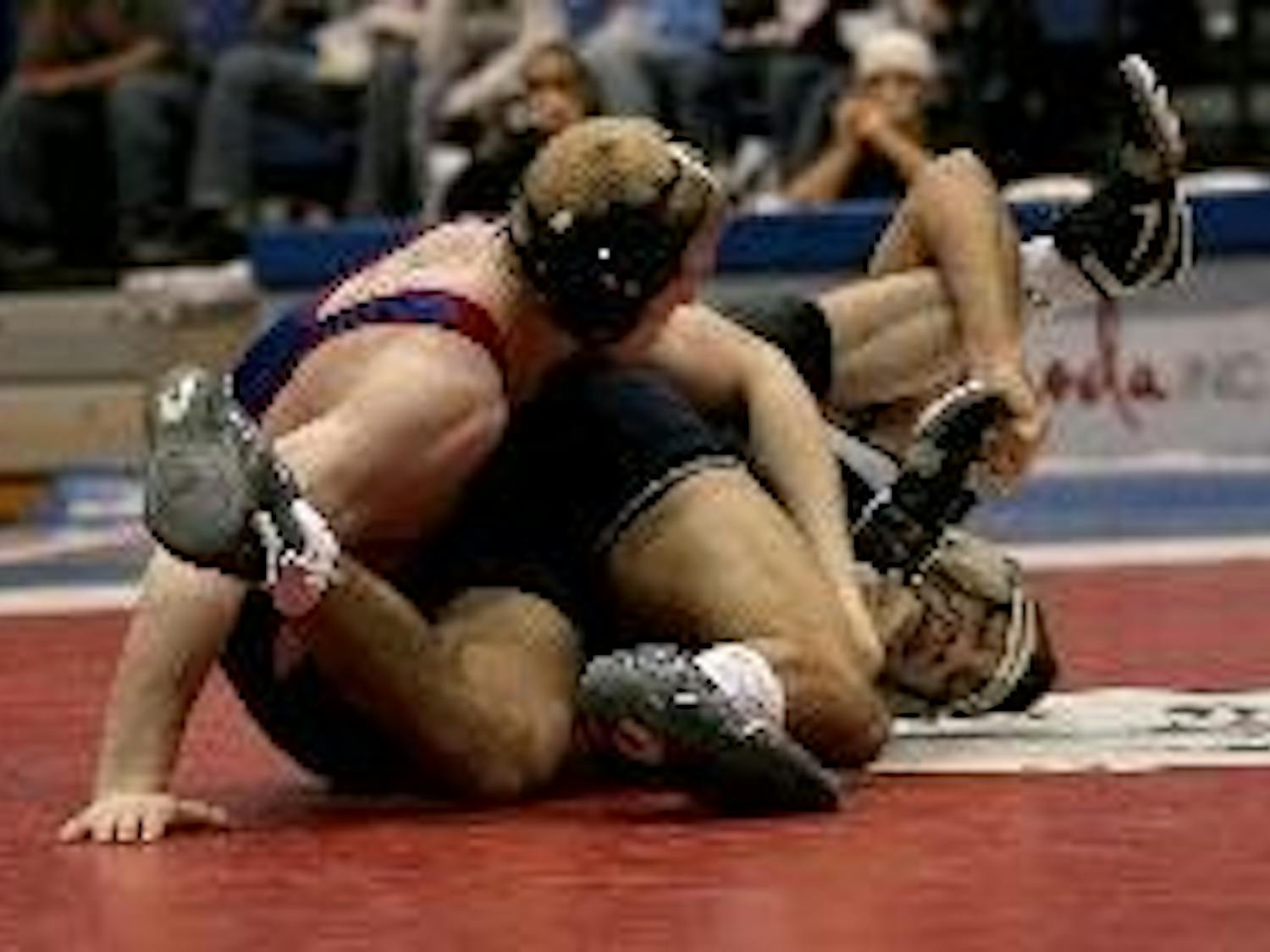 Though red shirt sophomore Mike Cannon (above left) won his bout in the 165-lb. weight class at yesterday's home wrestling match, only three of his teammates were able to do the same. Old Dominion came out on top 31-12.