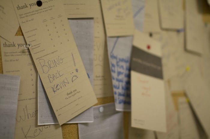 Students call for Kevin Nelsonâ€™s return on TDR comment cards outside the dining room. 