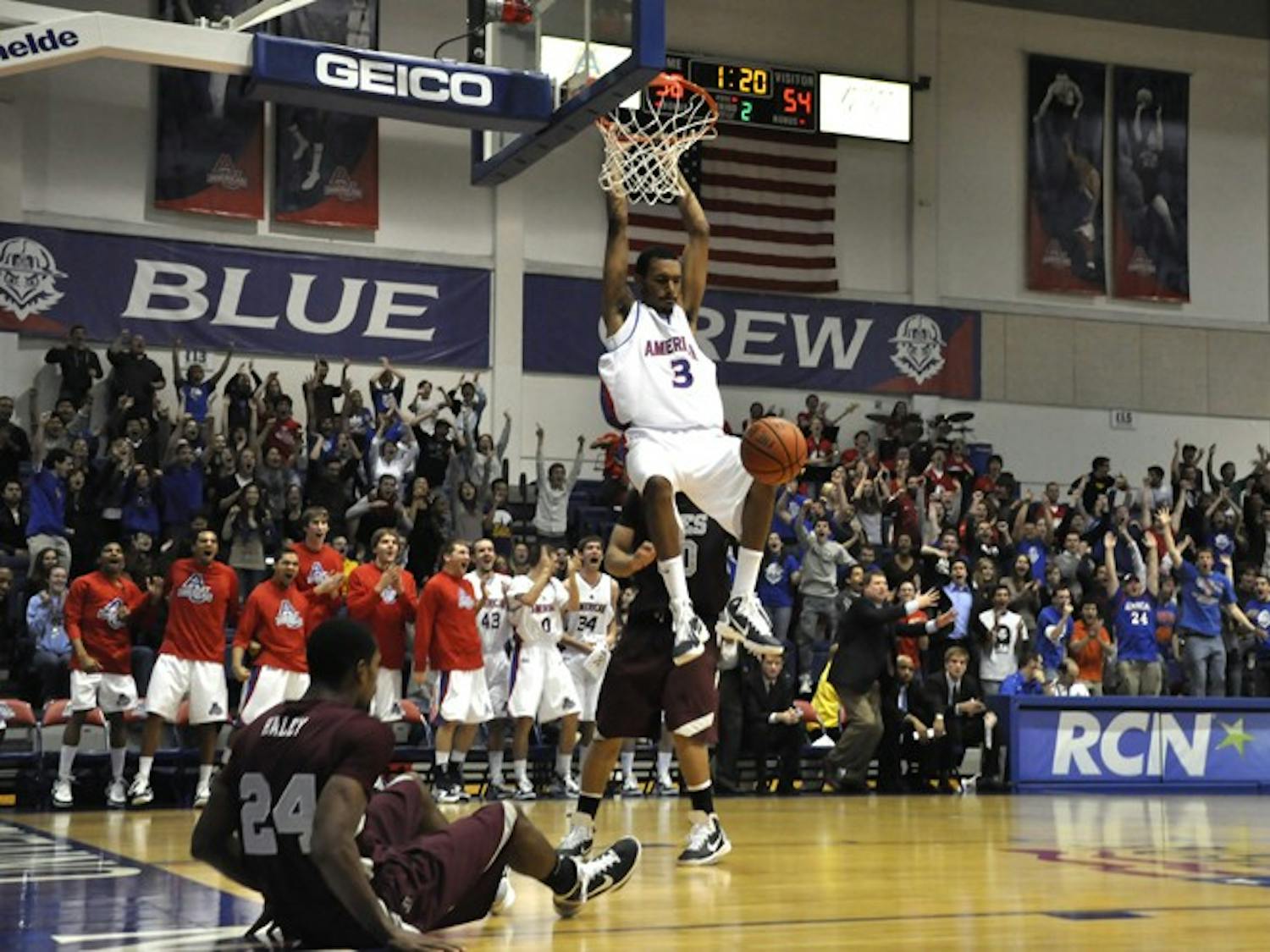 Junior guard Troy Brewer hangs on the rim during the second half of Wednesday\'s win against UMES.