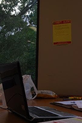 SAFETY FIRST - A laptop sits unattended in Bender Library near a sign that warns patrons of recent laptop thefts. Students have reported four laptops as stolen from the library between Monday and Thursday last week. 