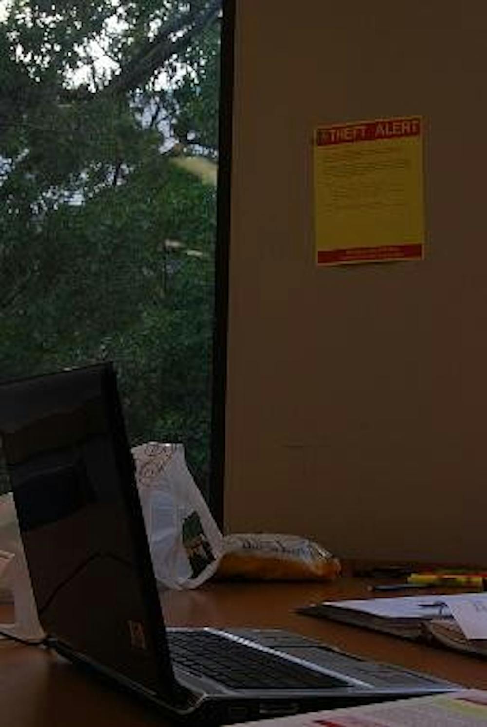 SAFETY FIRST - A laptop sits unattended in Bender Library near a sign that warns patrons of recent laptop thefts. Students have reported four laptops as stolen from the library between Monday and Thursday last week. 