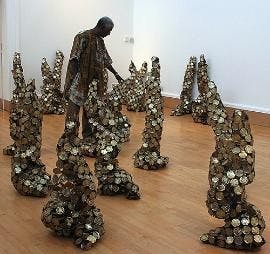 HEAVY METAL - El Anatsui's exhibit "Gawu" at the National Museum of African Art displays his stunning sculpture made from discarded metal. He transforms waste, including milk tin caps and scrap copper metal, into enormous and unexpectedly flexible works s