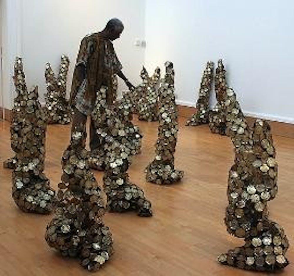 HEAVY METAL - El Anatsui's exhibit "Gawu" at the National Museum of African Art displays his stunning sculpture made from discarded metal. He transforms waste, including milk tin caps and scrap copper metal, into enormous and unexpectedly flexible works s