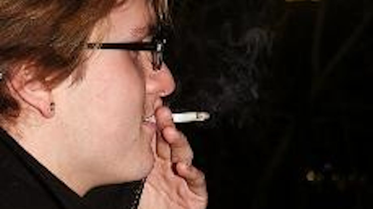 LOW BURN - Damien Chevaillier, a freshman in the School of International Service, smokes on the stairs in front of Mary Graydon Center. If the Undergraduate Senate passes new smoking restrictions, he would not be able to smoke at the entrances or exits of