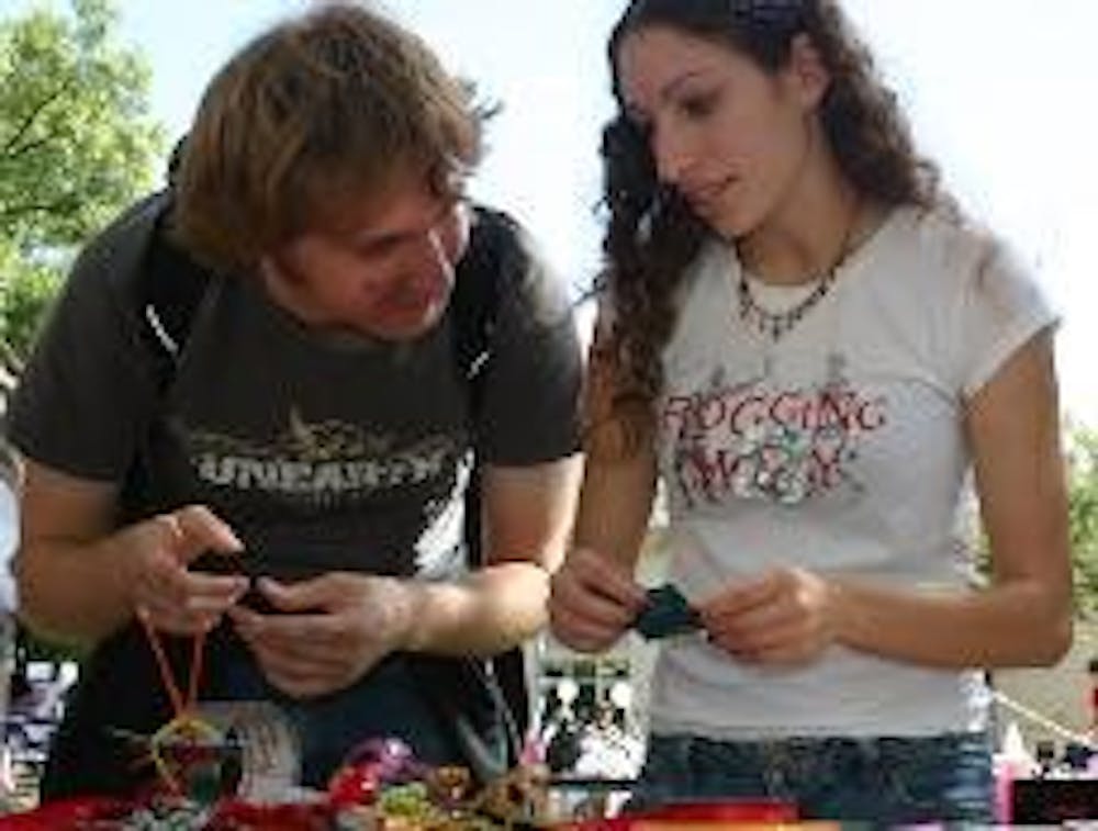 CONDOM CREATIVITY - Students make jewelry with condoms and other materials, including ribbons, at the annual Breastival Tuesday.