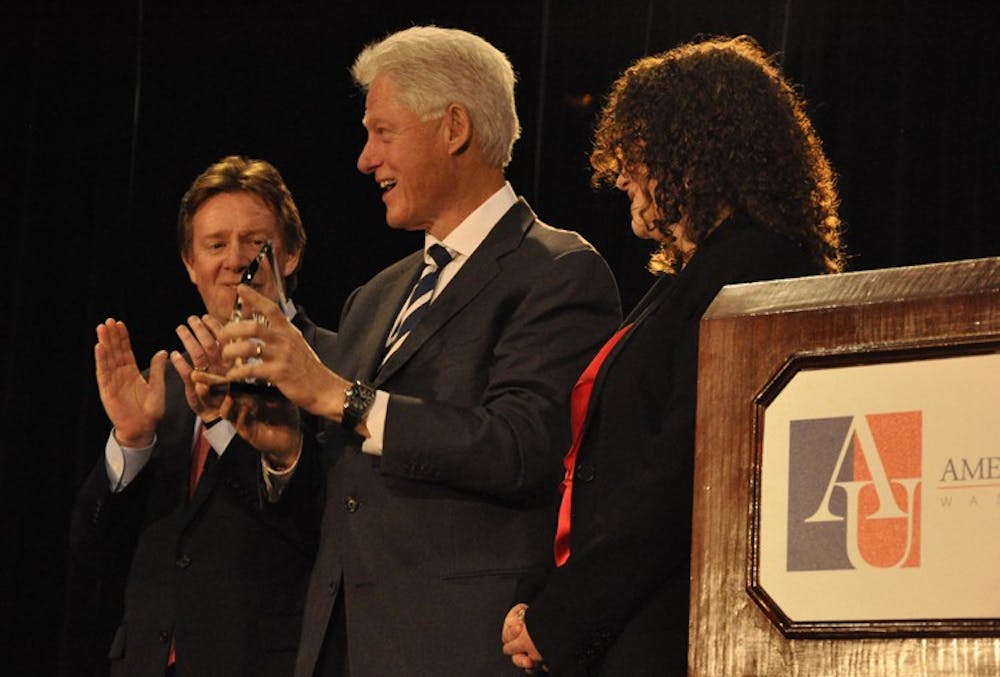 Clinton accepted the \"Wonk of the Year\" award from AU President Neil Kerwin and KPU Director Alex Kreger.
