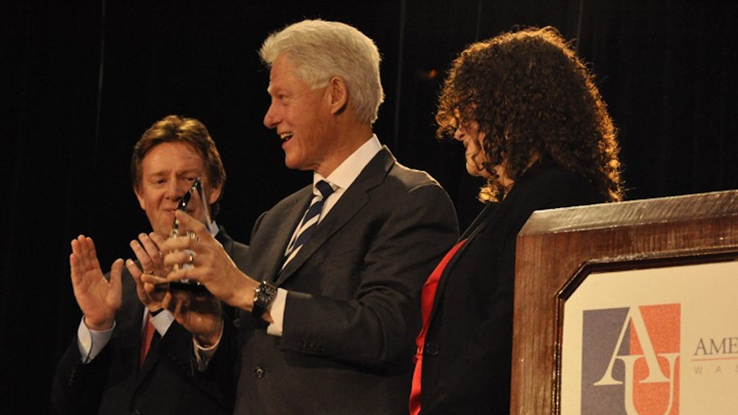 Clinton accepted the \"Wonk of the Year\" award from AU President Neil Kerwin and KPU Director Alex Kreger.