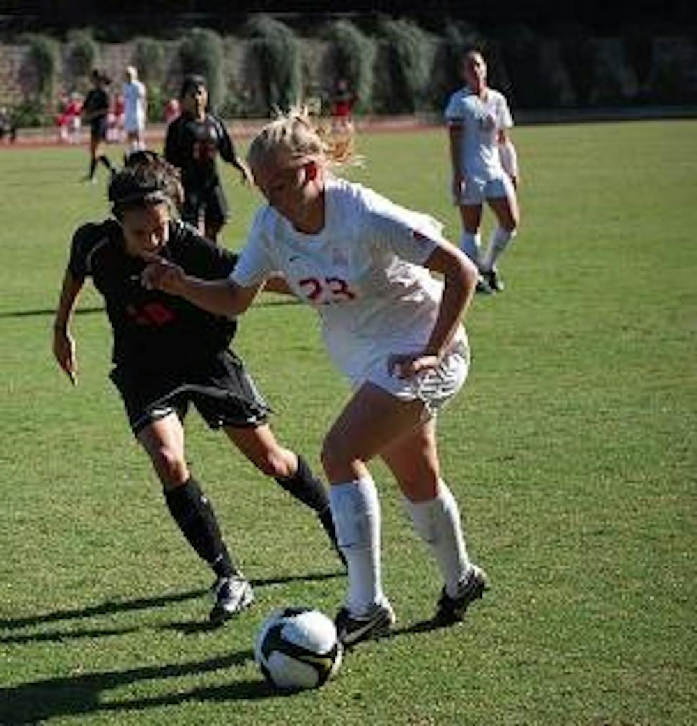 STRUGGLING - Senior forward Krystn Hodge (No. 23, above) attempts to dribble around her opponent while teammate junior forward Mary Riegler (No. 27, below) tries do the same in the recent loss to Princeton.  The loss was the seventh straight game the team