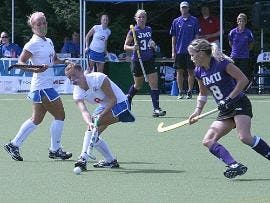 STICK PLAY - Freshman midfielder Tatum Dyer (No. 8) dribbles by her JMU opponent as senior midfielder Jesika Pufnock (No. 11) looks on. The Eagles lost their second straight game to a top 10 opponent, losing to JMU 1-0.  AU plays the University of Richmon