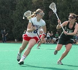 KEEP AWAY - Like in their game against George Mason (pictured here), the Eagles lost to Navy on Tuesday. Junior attacker Kira Sonberg scored a goal in the second half of play Tuesday. 